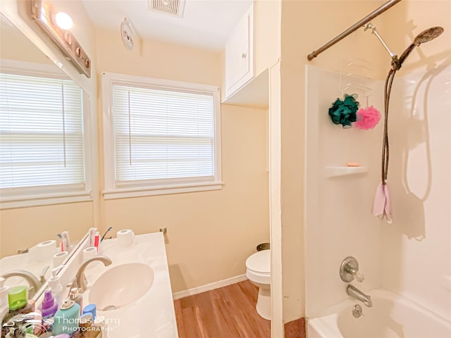 3816 State St, Abilene, TX 79603 - full bathroom featuring toilet, wood finished floors, bathtub / shower combination, vanity, and baseboards