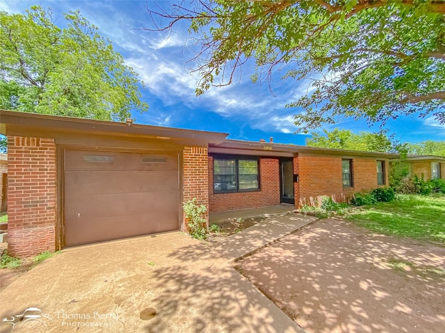 3816 State St, Abilene, TX 79603 - ranch-style house featuring brick siding, an attached garage, and concrete driveway