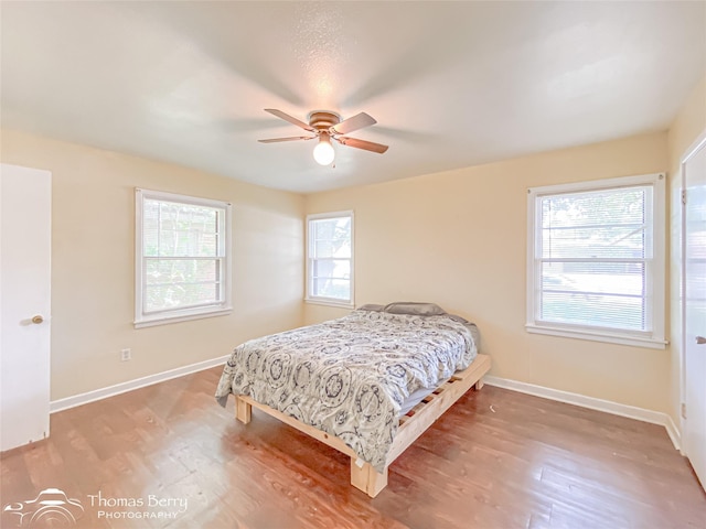 3816 State St, Abilene, TX 79603 - bedroom with wood finished floors, baseboards, and a ceiling fan