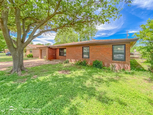 3816 State St, Abilene, TX 79603 - view of front of home with brick siding, a front lawn, and driveway