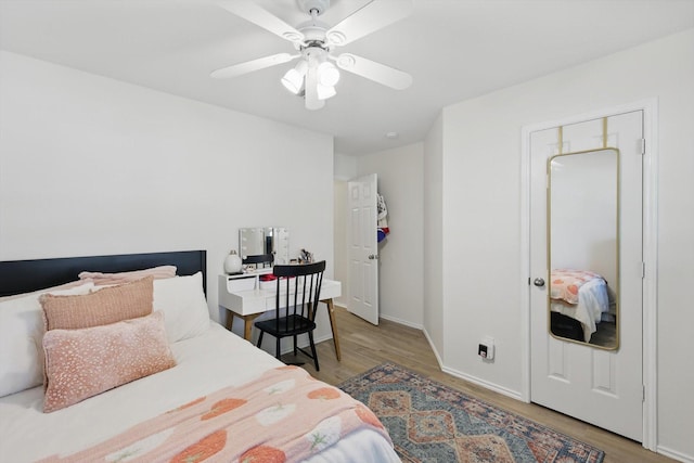 216 Hilltop Dr, Justin, TX 76247 - bedroom with wood finished floors, baseboards, and ceiling fan