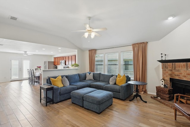 216 Hilltop Dr, Justin, TX 76247 - living room featuring a ceiling fan, lofted ceiling, plenty of natural light, and light wood-style flooring