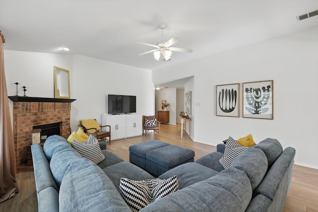 216 Hilltop Dr, Justin, TX 76247 - living area with a ceiling fan, light wood-type flooring, and a brick fireplace