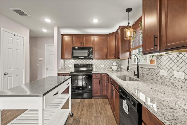 9104 Lookout Pt, Fort Worth, TX 76179 - kitchen featuring black appliances, a sink, light wood-style flooring, decorative backsplash, and decorative light fixtures
