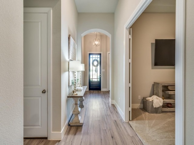 2724 Eccleston St, Celina, TX 75009 - entrance foyer featuring arched walkways, wood finished floors, and baseboards