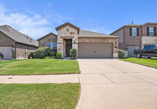 2535 Candle Ln, Northlake, TX 76247 - view of front of property featuring driveway, a garage, a front lawn, and stone siding