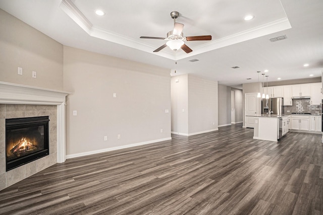 2535 Candle Ln, Northlake, TX 76247 - unfurnished living room with a raised ceiling, a ceiling fan, dark wood-type flooring, recessed lighting, and ornamental molding