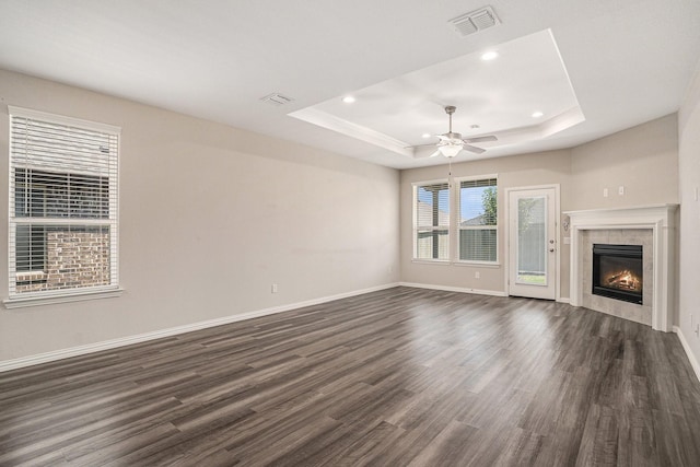2535 Candle Ln, Northlake, TX 76247 - unfurnished living room featuring a tray ceiling, dark wood finished floors, baseboards, a tiled fireplace, and recessed lighting