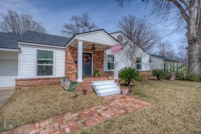 444 Albert Ave, Shreveport, LA 71105 - view of front of house with a front lawn, ceiling fan, brick siding, roof with shingles, and an attached garage