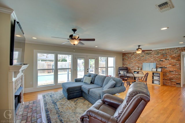444 Albert Ave, Shreveport, LA 71105 - living room featuring ceiling fan, a fireplace with flush hearth, light wood-style flooring, recessed lighting, and crown molding