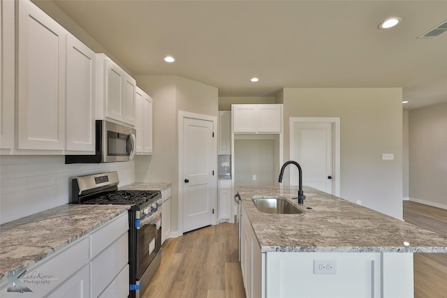 3458 Pewter Ln, Abilene, TX 79601 - kitchen featuring appliances with stainless steel finishes, a sink, recessed lighting, tasteful backsplash, and light wood finished floors