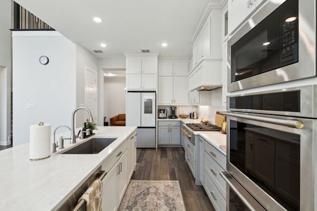 12469 Diamond Creek Dr, Frisco, TX 75035 - kitchen with a sink, stainless steel appliances, dark wood-style floors, white cabinets, and recessed lighting