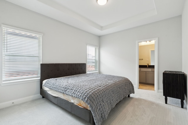 12469 Diamond Creek Dr, Frisco, TX 75035 - bedroom with light carpet, baseboards, a raised ceiling, and ensuite bathroom