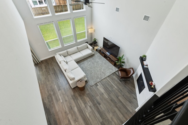 12469 Diamond Creek Dr, Frisco, TX 75035 - living area featuring a ceiling fan, wood finished floors, a towering ceiling, and baseboards
