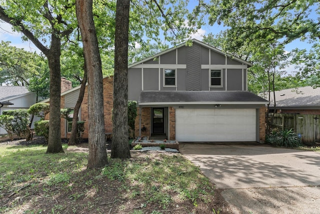 4910 Crest Dr, Arlington, TX 76017 - mid-century modern home featuring an attached garage, driveway, stucco siding, and brick siding