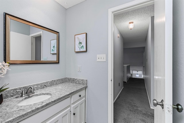 4910 Crest Dr, Arlington, TX 76017 - bathroom with vanity, a textured ceiling, and baseboards