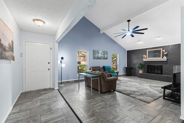 4910 Crest Dr, Arlington, TX 76017 - living area featuring baseboards, ceiling fan, stone tile flooring, a brick fireplace, and a textured ceiling