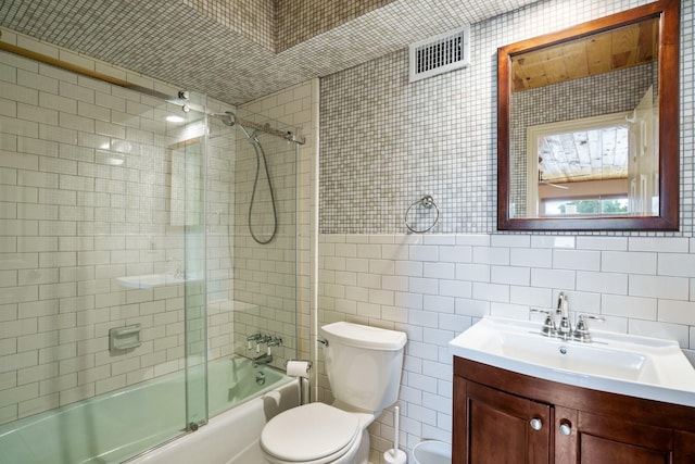 6853 Anglebluff Cir, Dallas, TX 75248 - bathroom with tile walls, vanity, toilet, and combined bath / shower with glass door