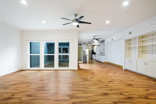 6853 Anglebluff Cir, Dallas, TX 75248 - unfurnished living room featuring ceiling fan, wood finished floors, recessed lighting, built in shelves, and baseboards