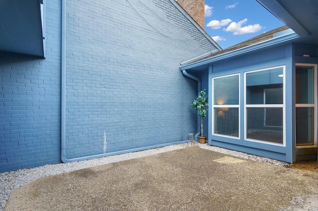 6853 Anglebluff Cir, Dallas, TX 75248 - view of side of property featuring brick siding, a patio, and a chimney