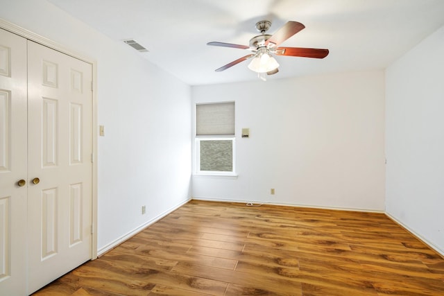 6853 Anglebluff Cir, Dallas, TX 75248 - unfurnished bedroom featuring wood finished floors, a ceiling fan, a closet, and baseboards