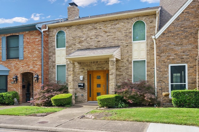 6853 Anglebluff Cir, Dallas, TX 75248 - view of front of property featuring a chimney, brick siding, and a front yard