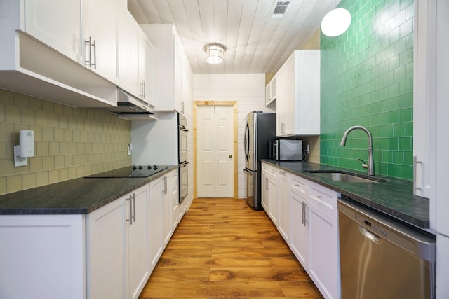 6853 Anglebluff Cir, Dallas, TX 75248 - kitchen featuring appliances with stainless steel finishes, a sink, and white cabinetry