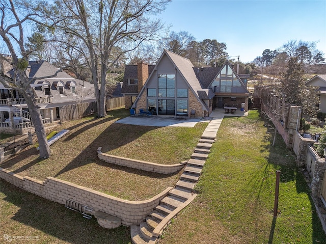 5607 S Lakeshore Dr, Shreveport, LA 71119 - rear view of house featuring a patio and a chimney