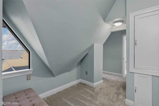 5607 S Lakeshore Dr, Shreveport, LA 71119 - additional living space with lofted ceiling, baseboards, carpet flooring, and a water view