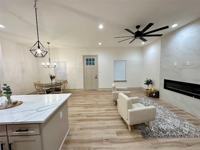 400 N Kenny Dr, West Tawakoni, TX 75474 - living room featuring light wood-type flooring, a ceiling fan, a premium fireplace, and recessed lighting