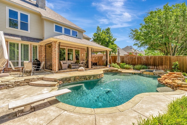 405 Martel Ln, Coppell, TX 75019 - view of pool featuring a fenced backyard, a patio area, an outdoor living space, a pool with connected hot tub, and a diving board