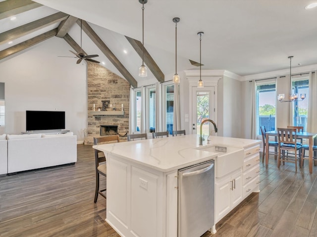 3025 Infinity Dr, Weatherford, TX 76087 - kitchen with dishwasher, a sink, light stone counters, a fireplace, and dark wood-type flooring