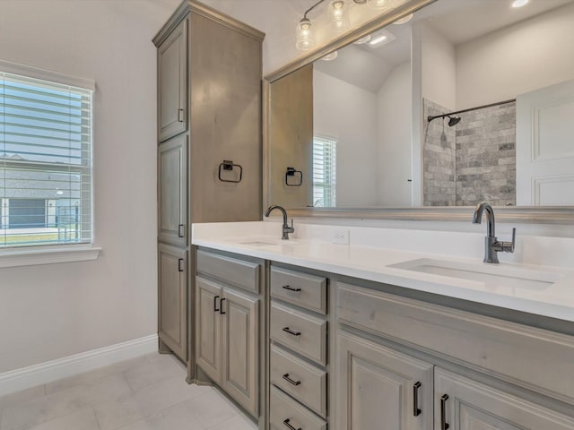 3025 Infinity Dr, Weatherford, TX 76087 - bathroom with double vanity, tiled shower, tile patterned flooring, and baseboards