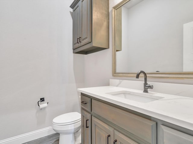3025 Infinity Dr, Weatherford, TX 76087 - bathroom featuring vanity, toilet, baseboards, and wood finished floors