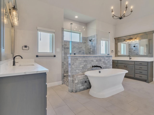 3025 Infinity Dr, Weatherford, TX 76087 - full bath featuring a walk in shower, two vanities, a chandelier, and a freestanding bath
