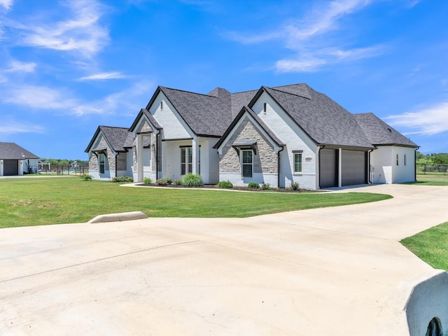 3025 Infinity Dr, Weatherford, TX 76087 - french provincial home featuring a front lawn, stone siding, an attached garage, driveway, and roof with shingles