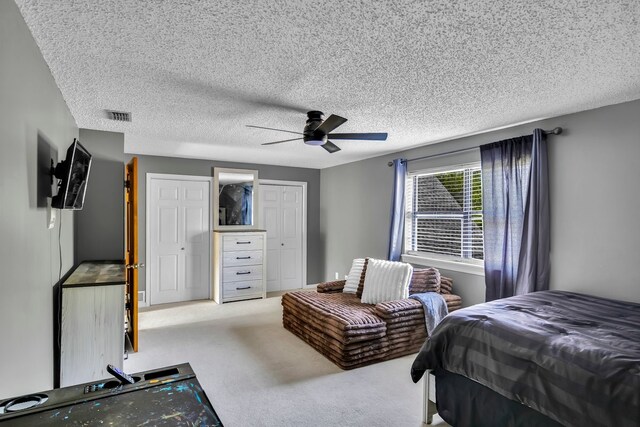 213 County Road 1407, Jacksonville, TX 75766 - bedroom with a textured ceiling, ceiling fan, carpet flooring, and a closet