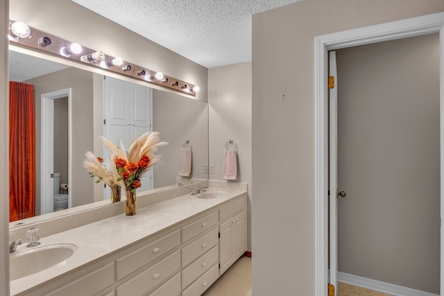 213 County Road 1407, Jacksonville, TX 75766 - full bath with double vanity, a textured ceiling, and toilet