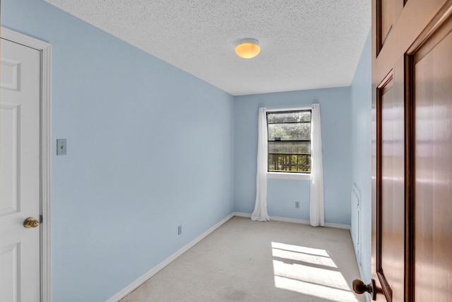 213 County Road 1407, Jacksonville, TX 75766 - unfurnished bedroom featuring a textured ceiling, light colored carpet, and baseboards