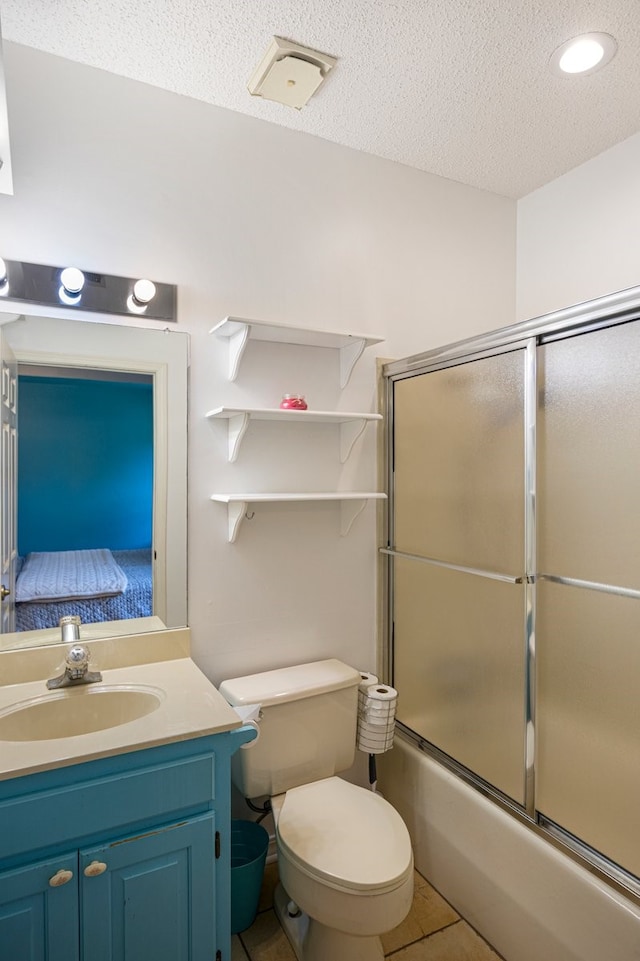 213 County Road 1407, Jacksonville, TX 75766 - bathroom with bath / shower combo with glass door, vanity, toilet, a textured ceiling, and tile patterned flooring