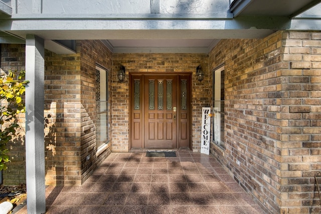 213 County Road 1407, Jacksonville, TX 75766 - view of exterior entry featuring brick siding and covered porch
