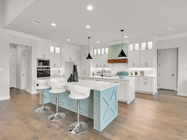 213 Martin Dr, Granbury, TX 76049 - kitchen with a large island, appliances with stainless steel finishes, crown molding, a sink, and recessed lighting