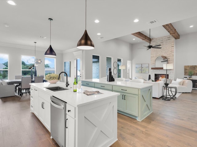 213 Martin Dr, Granbury, TX 76049 - kitchen featuring a sink, a kitchen island with sink, stainless steel dishwasher, open floor plan, and beam ceiling