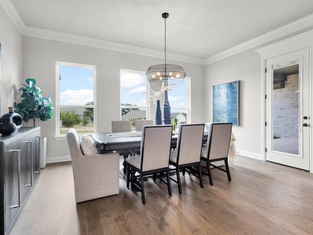 213 Martin Dr, Granbury, TX 76049 - dining room featuring wood finished floors, a chandelier, crown molding, and baseboards