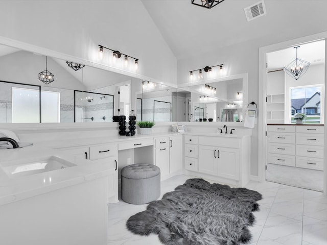 213 Martin Dr, Granbury, TX 76049 - full bathroom with marble look tiles, a chandelier, a shower stall, double vanity, and high vaulted ceiling