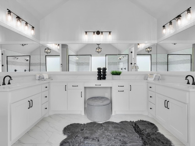 213 Martin Dr, Granbury, TX 76049 - bathroom featuring marble look tiles, vaulted ceiling, a shower stall, and double vanity