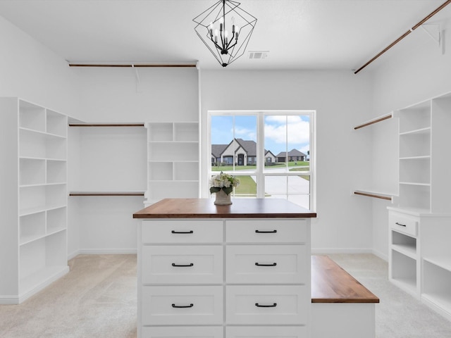 213 Martin Dr, Granbury, TX 76049 - walk in closet featuring light carpet and a chandelier