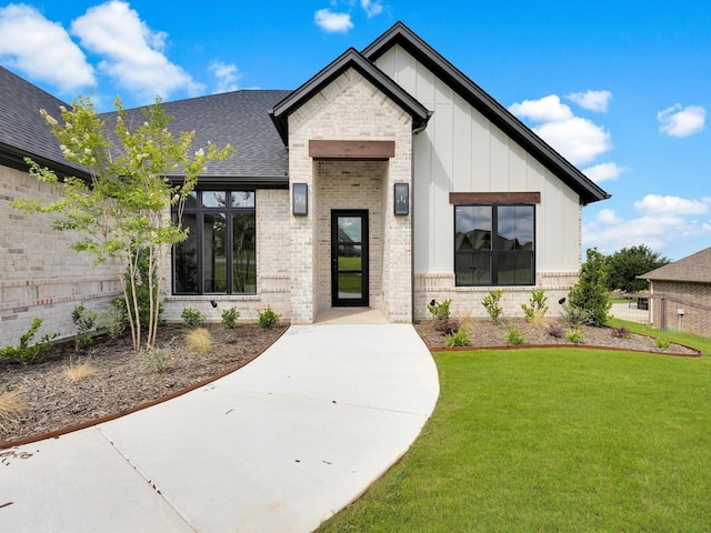 213 Martin Dr, Granbury, TX 76049 - doorway to property featuring brick siding, board and batten siding, and a shingled roof