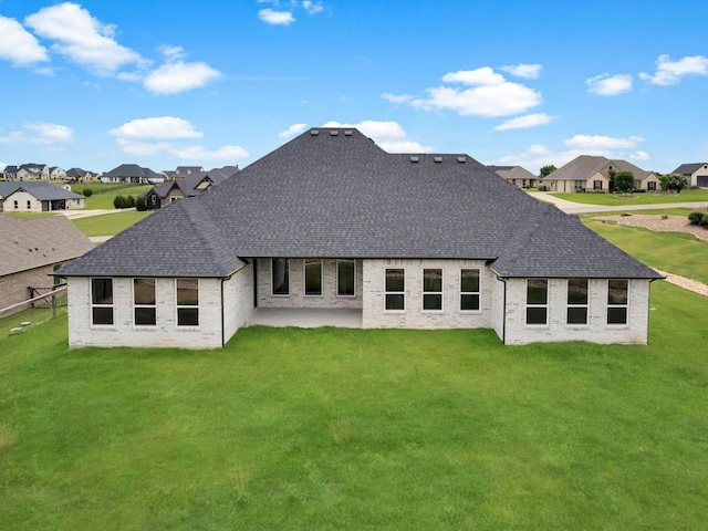 213 Martin Dr, Granbury, TX 76049 - rear view of house with a shingled roof, a residential view, a yard, and brick siding