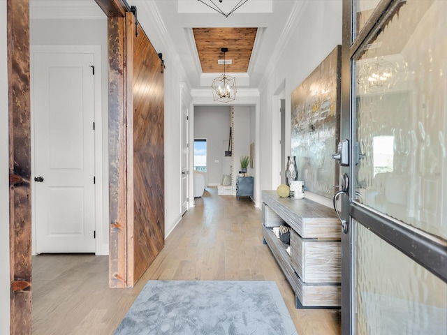 213 Martin Dr, Granbury, TX 76049 - corridor featuring a chandelier, light wood-style flooring, a barn door, ornamental molding, and baseboards